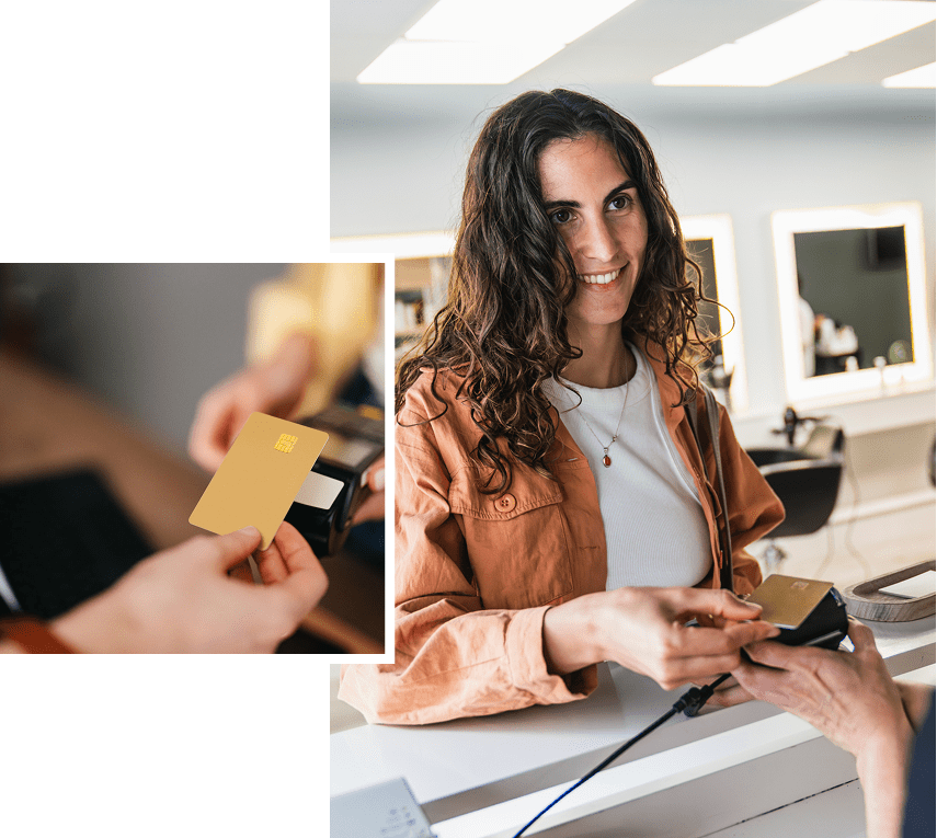 Woman paying with card at reception desk.
